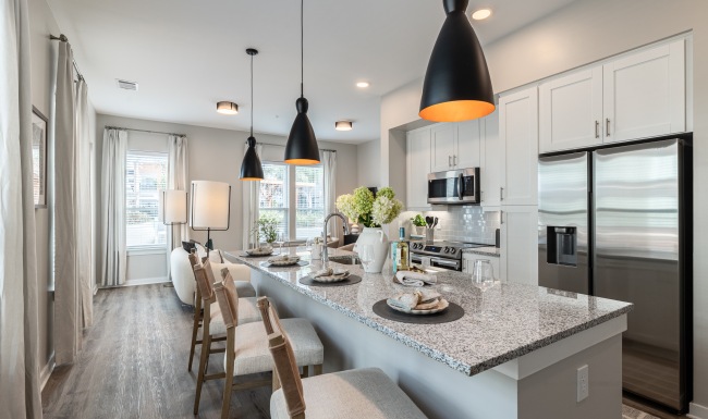 Kitchen kitchen island with pendant lighting  and white cabinets