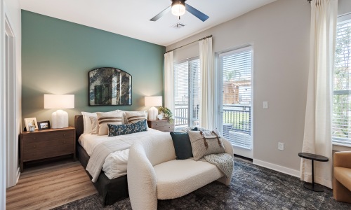 Furnished bedroom with a green accent wall at Pilot & Park pet-friendly apartments in Savannah, GA	